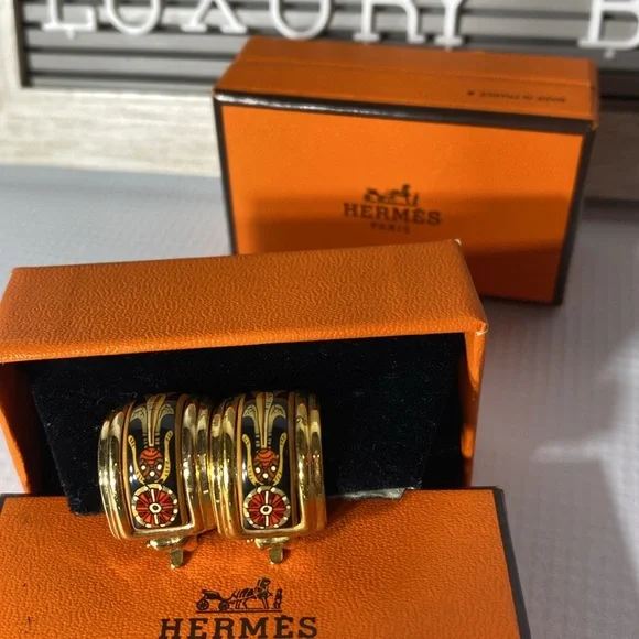 Hermes clip on earrings one blue and one red chose one